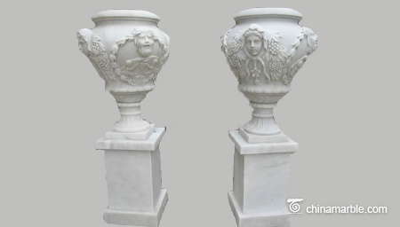 Urn-with-face-carving-