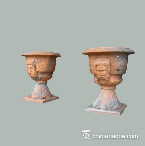 Planter-with-face-carving-